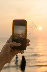 日落时用手机打电话电话旅行游客照片细胞天空相机技术摄影师摄影图片