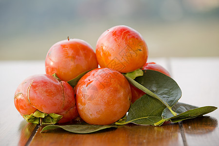 persimmon 半西蒙热带季节团体果味桌子食物水果叶子小吃营养图片
