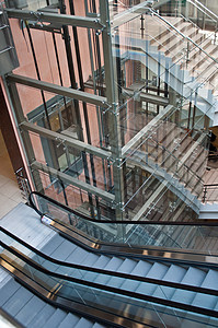 现代办公大楼的玻璃升起井和扶梯建筑小路运动自动扶梯速度建筑学脚步办公室旅行运输图片