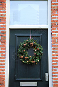 古老的圣诞节花环 门上有装饰装饰品季节庆典风格门廊蓝色玻璃木头假期丝带图片