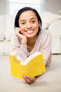深褐色微笑阅读书闲暇客厅沙发家庭生活公寓家庭混血阅读休息室桌子图片