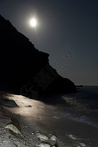 月亮夜在海中黑暗海浪岩石石头孤独旅行天空场景海滩月光图片