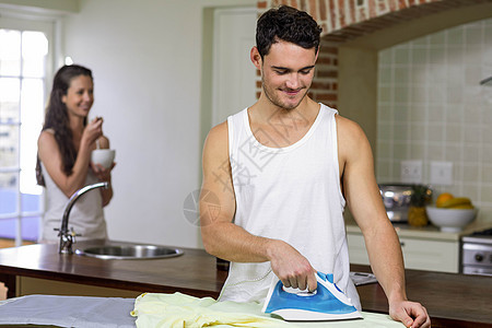 在厨房里熨衬衣家务住所熨烫男人背心家庭情人家庭生活男性女性图片