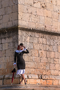 穿旧旧礼服的年轻红发女孩女性角落冒充太阳城市微笑晴天美丽街道魅力图片