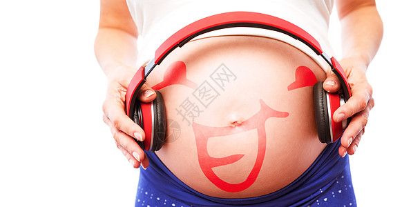 孕妇用耳机压住双耳机的复合图像音乐女性女士腹部身体孕妇装休闲听力卡通片涂鸦图片
