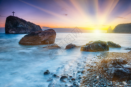 海滩日落岩石天空海景地平线戏剧性紫色场景海洋晴天季节图片
