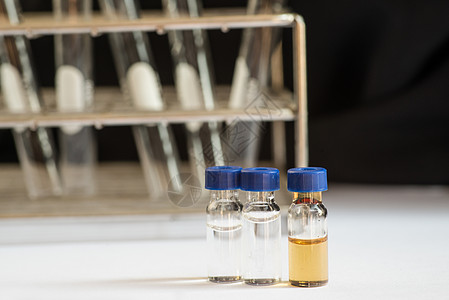 实验室玻璃器件前面的蓝盖小瓶化学技术学校生物液体化学家瓶子微生物学器皿实验图片