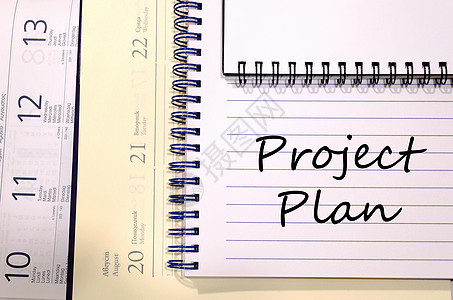 在笔记本上写项目计划顾问日程经理战略公司控制流程图团队解决方案程序图片