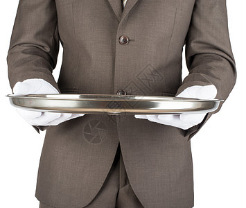 持有空银盘的服务员展示盘子职员推介会顾客托盘男性套装工作餐厅图片
