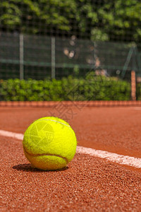 红土球场上的网球设备竞赛背光橙子基线射线游戏红色日落球拍黄色图片