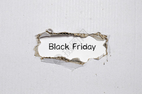 黑色的周五这个词出现在撕破纸后面价格商业交易促销零售假期互联网礼物产品顾客图片