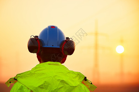 日出时的工人安全帽导师工作服电缆线电气职员基础设施高压日落电塔图片
