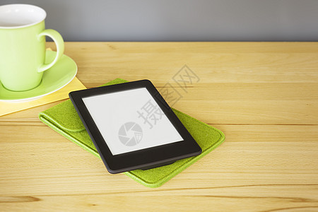 木制桌上的电子书阅读器屏幕教育白色早餐木头药片桌子互联网咖啡绿色图片