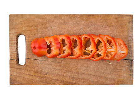 在旧的剪切板上切成胡椒砧板木头木板饮食蔬菜厨房辣椒香料烹饪橙子图片