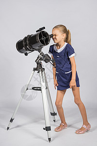 年轻的有趣的天文学家 透过望远镜的眼镜看望着图片