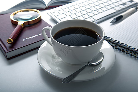 工作场所的咖啡早餐会静物记事本键盘办公室组织床单外表台面桌面日记图片