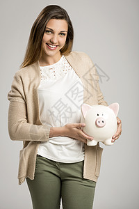 妇女持有小猪银行储蓄银行小猪金融女性拉丁商业投资快乐灰色图片