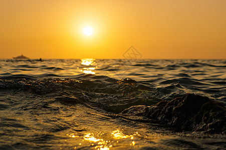 海浪在日落时紧闭 红色和橙色的太阳反射到水面上 自然抽象地模糊背景 泰国普吉岛天空波浪旅行假期冲浪阳光背光地平线海景反思图片