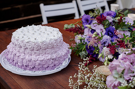 喜庆婚礼蛋糕和一束花放在桌子上甜点花朵餐饮奢华盘子接待派对水果玻璃庆典图片