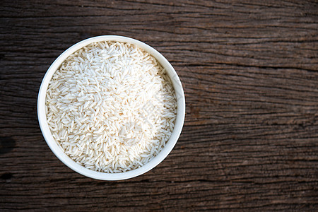 白碗里粘黏的米饭桌子饮食产品食物木头绿色植物收成白色背景图片