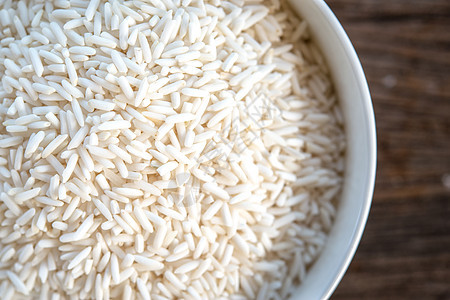 白碗里粘黏的米饭木头食物绿色白色饮食植物收成桌子产品背景图片