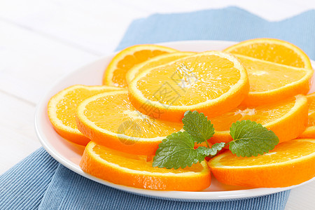 背景橙子新鲜橙色薄片水果白色盘子团体蓝色折叠食物热带餐垫背景
