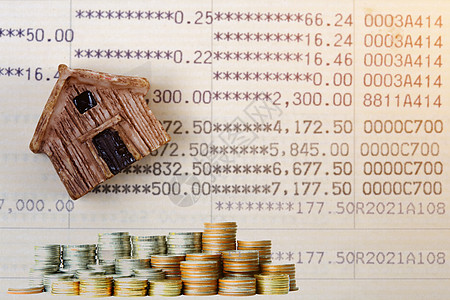 金融概念账户账簿的本房模型堆叠了硬币图片