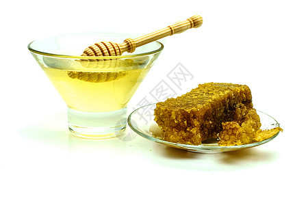 蜂蜜与蜂窝在玻璃板上隔离在白色背景糖浆产品液体木头甜点金子早餐食物营养药品图片