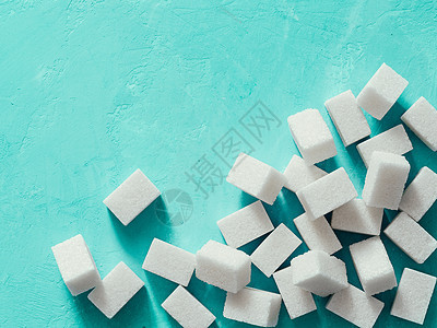 蓝色混凝土背景白糖立方体的顶部视图糖尿病精制产品活力添加剂葡萄糖正方形食物颗粒状蔗糖图片