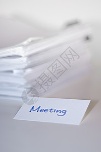 会议; 白桌和背景上的文件堆放图片