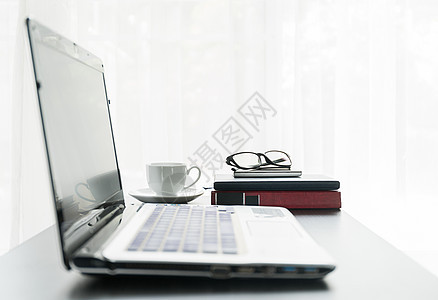 用咖啡杯放在桌面上的笔记本电脑工作展示杯子咖啡互联网眼镜监视器数据店铺办公室图片