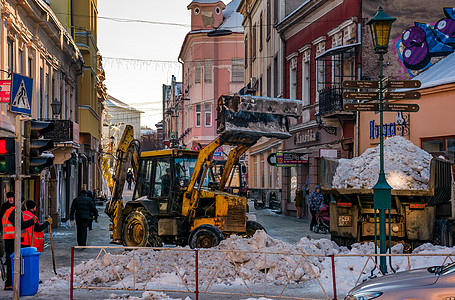 旧城街道上下雪天气机械工人建筑工作拖拉机房子建筑学街道车辆图片