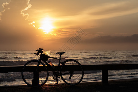 自行车和日出运输旅行工业橙子金子地平线黄色阳光天空红色图片