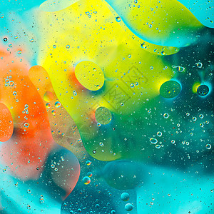 水面上的彩色斑点圈圆圈背景宏观绿色辉光液体玻璃气泡火花黄色图片
