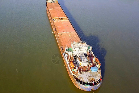 一艘货船沿河漂浮 货物船血管载体商业后勤天空海洋海岸线港口海岸货运图片