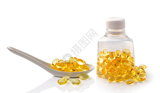 白底鱼油药片药品营养胶囊黄色宏观白色卫生凝胶医疗药店图片