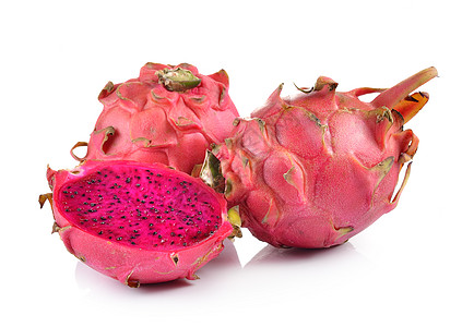 白色背景的红龙果热带粉色异国饮食红色绿色种子情调食物营养图片