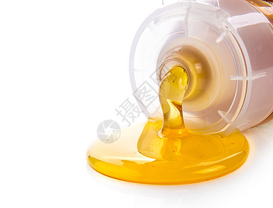 白底隔离的塑料管蜂蜜中的蜂蜜图片