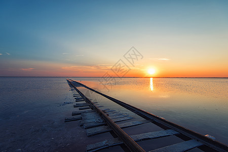 咸湖上的美日落铁路天空传统土地蓝色橙子盐水晴天文化太阳图片