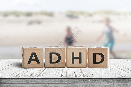 ADHD 在有孩子的木制桌子上的ADHD标志图片