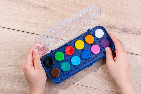 手持木制背景水彩油漆盒 手持水彩漆箱爱好蓝色托盘盒子画笔颜料盒白色补给品画家红色图片