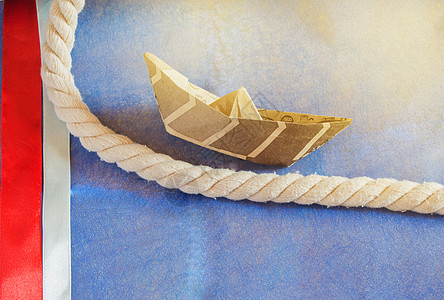 美国假日 蓝色背景和丝带装饰的快乐哥伦布日纸船 太阳能想像力假期红色时间绘画甲板问候语日历旗帜纸船图片