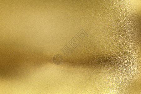 具有划痕表面抽象纹理背景的发光金色金属墙图片