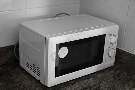在厨房里做饭或取暖的微波炉烤箱用具柜台炊具电子产品厨具食物器具技术火炉图片