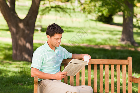 男人在看报纸男性花园闲暇长椅公园游戏填字幸福绿色咖啡图片