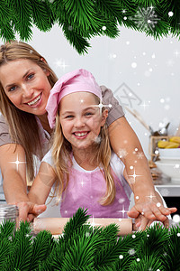 母亲和女儿在厨房烘烤圣诞节饼干的复合图象 表象图片