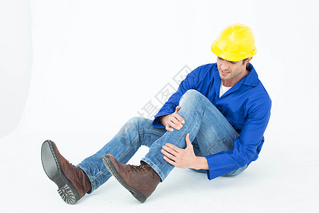 建筑师膝膝部疼痛伤害男人蓝色工人技术员安全帽工作按摩头盔身体图片