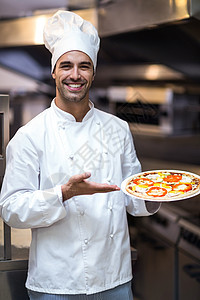 英俊的厨师介绍比萨饼快乐食物美食家餐厅职员厨房商业职业工作美食图片