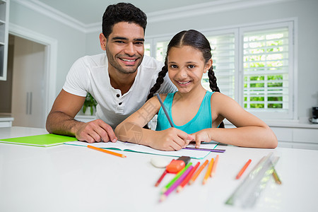 父亲在家协助女儿做作业孩子学习客厅亲密感家庭生活桌子家庭作业快乐住所铅笔图片