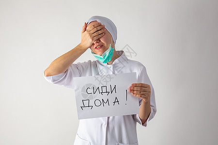 戴面罩的女医生手里握着一块石板     待在家里卫生控制暴发生物风险预防危害警告面具流感图片